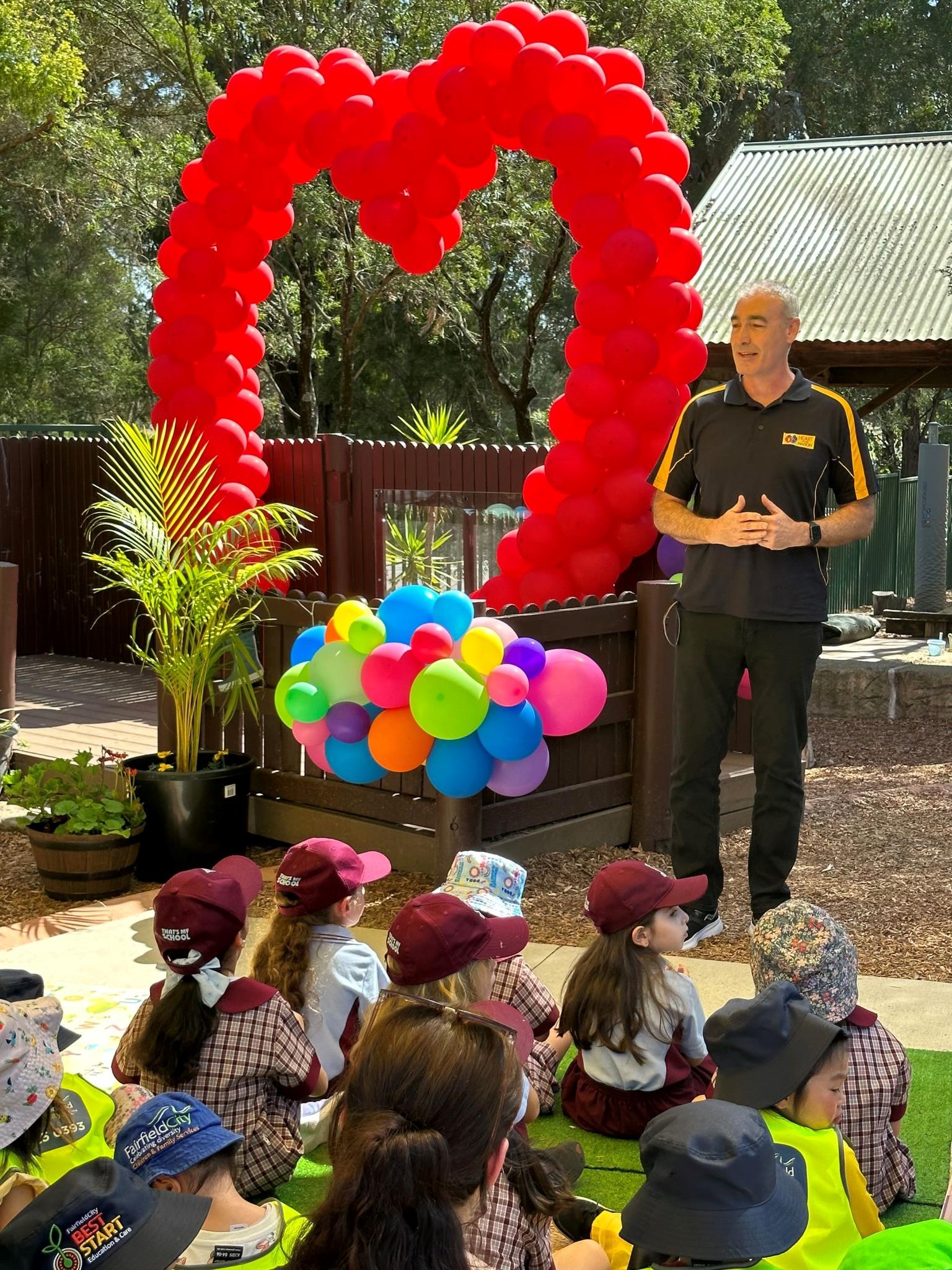 Yellow wiggle standing in front of crowd of children